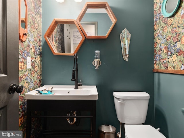 half bathroom featuring toilet and vanity
