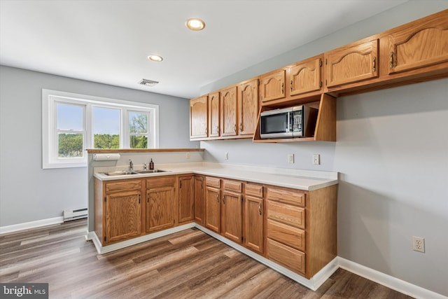 93 Shady Ln, Boyertown, PA 19512 - kitchen featuring a sink, light countertops, stainless steel microwave, a baseboard radiator, and visible vents
