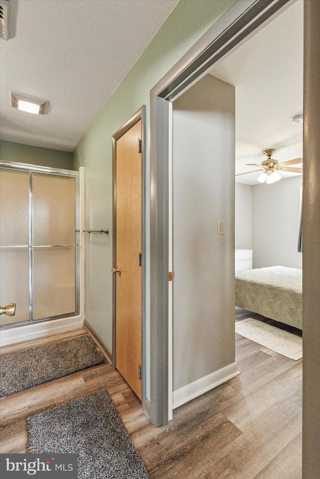 93 Shady Ln, Boyertown, PA 19512 - bathroom with an enclosed shower, baseboards, ceiling fan, and wood finished floors