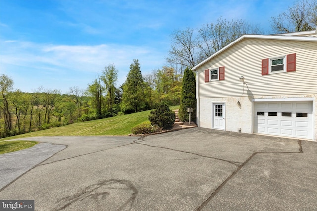 93 Shady Ln, Boyertown, PA 19512 - view of side of home featuring a lawn, an attached garage, and aphalt driveway