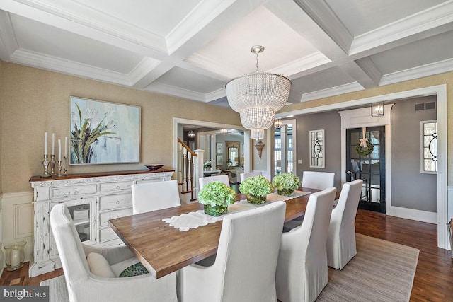 dining room with coffered ceiling, wood finished floors, a chandelier, healthy amount of natural light, and stairs