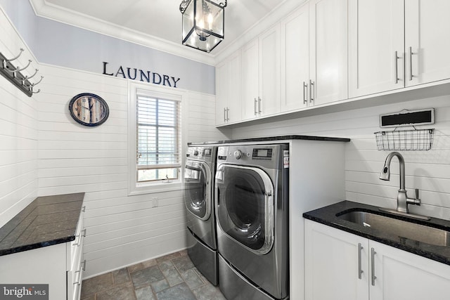 washroom with independent washer and dryer, cabinet space, dark stone finish floors, and crown molding