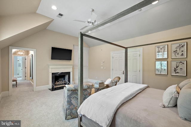bedroom featuring lofted ceiling, light colored carpet, a premium fireplace, recessed lighting, and ceiling fan