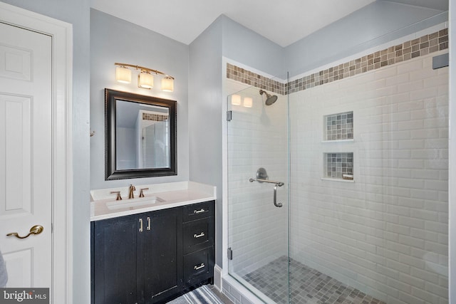 full bathroom featuring a shower stall and vanity
