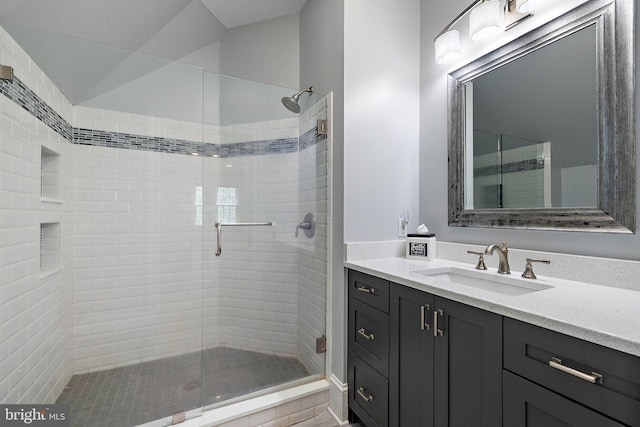 full bathroom with a shower stall and vanity