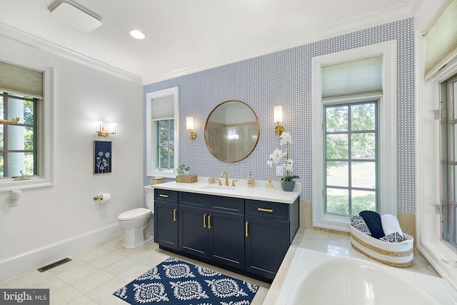 bathroom with ornamental molding, baseboards, toilet, plenty of natural light, and vanity
