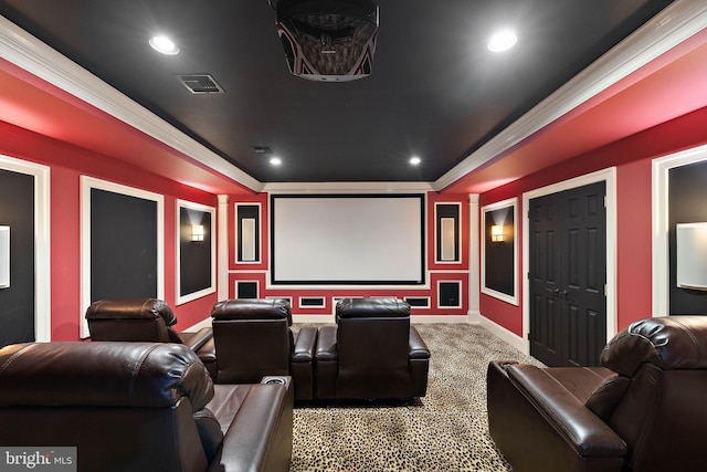 carpeted home theater room featuring baseboards, ornamental molding, and recessed lighting