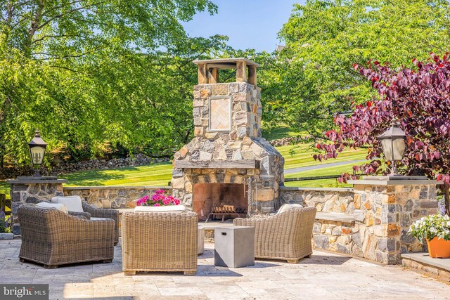 view of patio featuring an outdoor stone fireplace