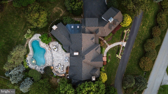 aerial view of property and surrounding area featuring a pool area