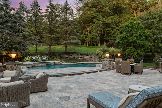 view of pool featuring a patio, outdoor dining area, and a pool with connected hot tub