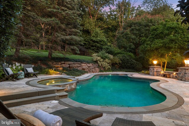 view of swimming pool with a patio area and a pool with connected hot tub
