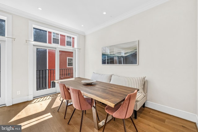 dining area with ornamental molding, recessed lighting, wood finished floors, and baseboards