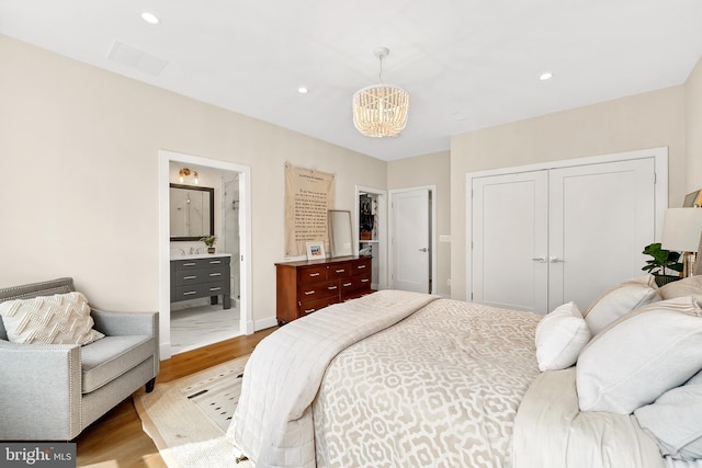 bedroom with a chandelier, visible vents, wood finished floors, and recessed lighting