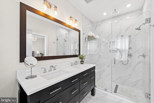 full bath featuring a marble finish shower, a sink, double vanity, and marble finish floor