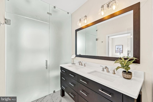 full bathroom with double vanity, marble finish floor, a stall shower, and a sink