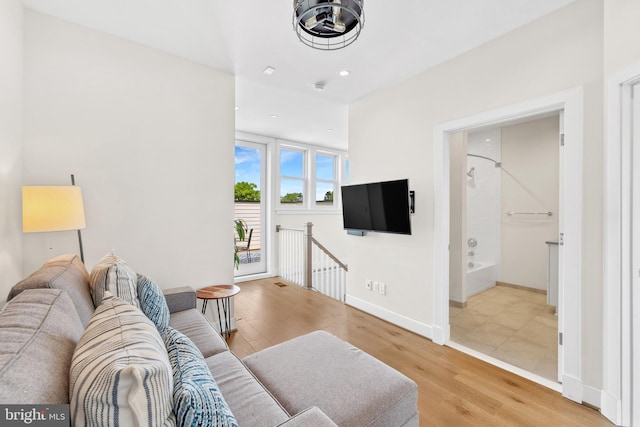 living room with baseboards, recessed lighting, and wood finished floors