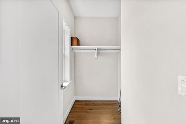 walk in closet featuring visible vents and wood finished floors