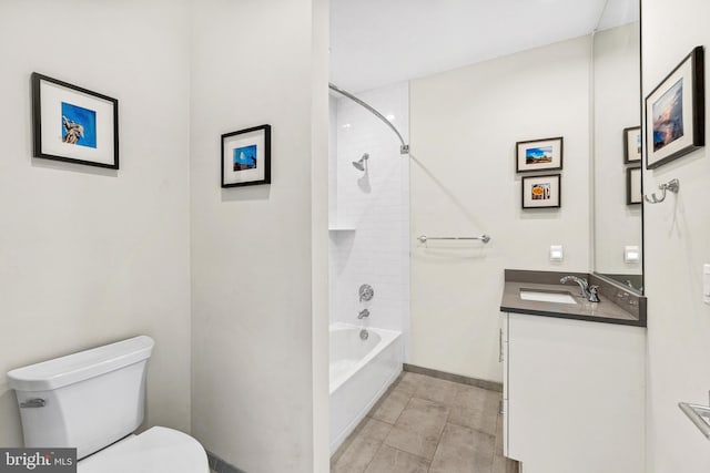 bathroom with baseboards, toilet, shower / bathtub combination, and vanity