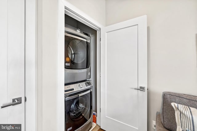 laundry room with stacked washer and dryer and laundry area