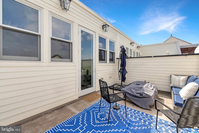 view of patio featuring fence and a grill