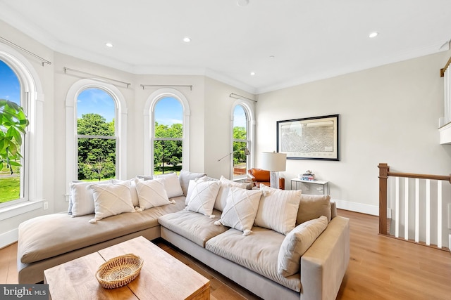 living room with a wealth of natural light, recessed lighting, and light wood-style flooring