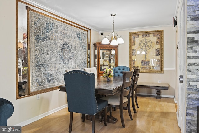 10519 Stonington Ln, Manassas, VA 20109 - dining space featuring crown molding, a chandelier, wood finished floors, and baseboards