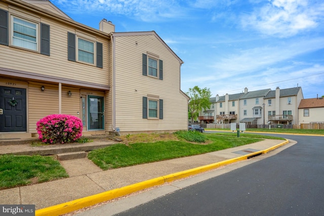 10519 Stonington Ln, Manassas, VA 20109 - view of front of house featuring a chimney, a residential view, a front lawn, and uncovered parking