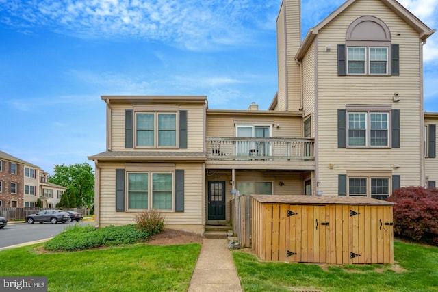 10519 Stonington Ln, Manassas, VA 20109 - multi unit property featuring a chimney, a front yard, and a balcony