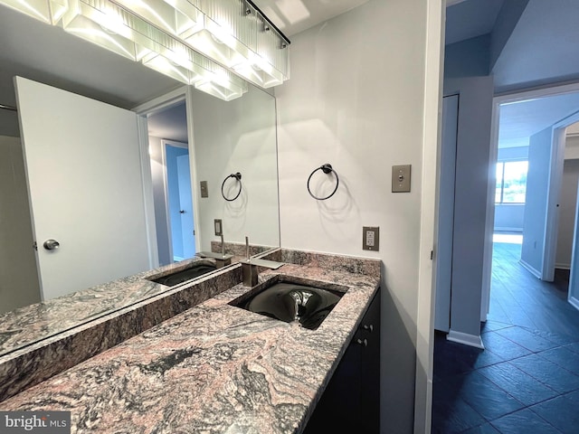 bathroom featuring baseboards and vanity