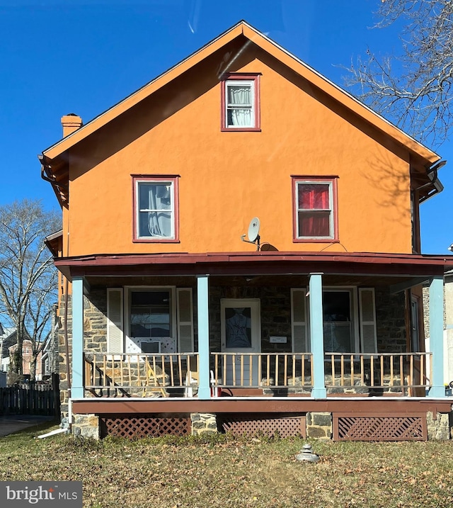 20 S Carol Blvd, Upper Darby, PA 19082 - rear view of house with covered porch, stucco siding, a chimney, and stone siding