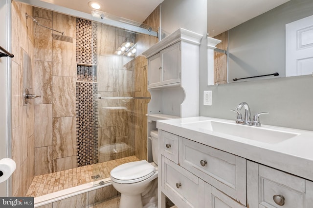 full bath with vanity, toilet, and a stall shower