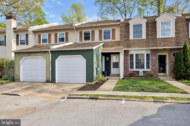 103 Debbie Ln, Phoenixville, PA 19460 - multi unit property featuring concrete driveway, brick siding, roof with shingles, and an attached garage