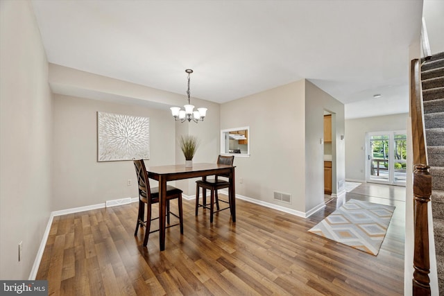 103 Debbie Ln, Phoenixville, PA 19460 - dining space with wood finished floors, visible vents, stairway, a chandelier, and baseboards