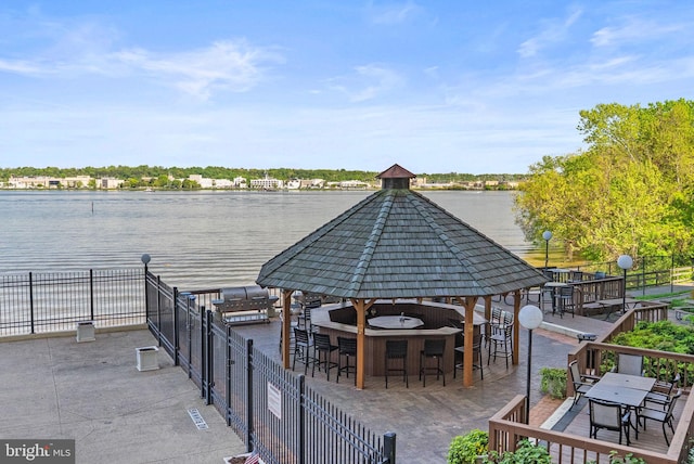 view of property's community featuring a gazebo, outdoor dry bar, and fence