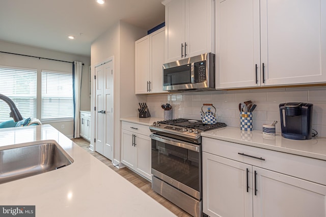 12461 Coastal Marsh Dr Unit 707, Berlin, MD 21811 - kitchen with stainless steel appliances, light countertops, tasteful backsplash, light wood finished floors, and recessed lighting