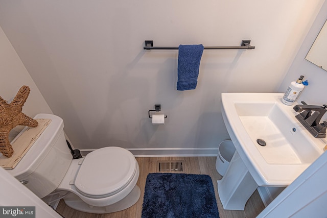 12461 Coastal Marsh Dr Unit 707, Berlin, MD 21811 - bathroom with toilet, wood finished floors, a sink, and baseboards
