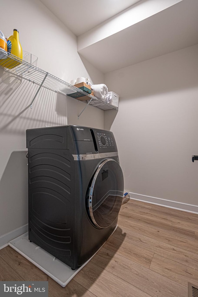 12461 Coastal Marsh Dr Unit 707, Berlin, MD 21811 - laundry area featuring wood finished floors, baseboards, and washer / clothes dryer