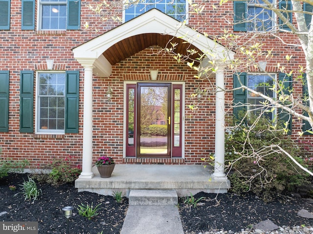 property entrance with brick siding