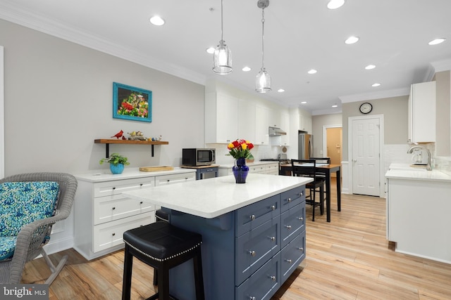 84 Battery Point Dr, Fredericksburg, VA 22406 - kitchen with stainless steel appliances, ornamental molding, white cabinetry, backsplash, and light countertops