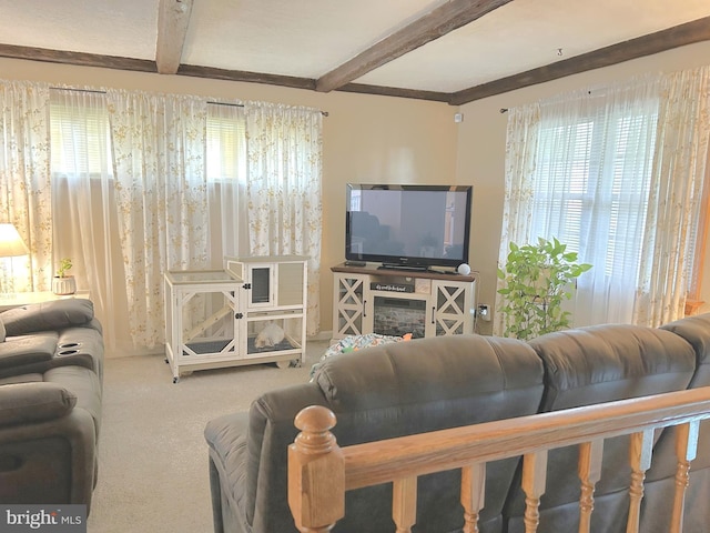 carpeted living room with beamed ceiling