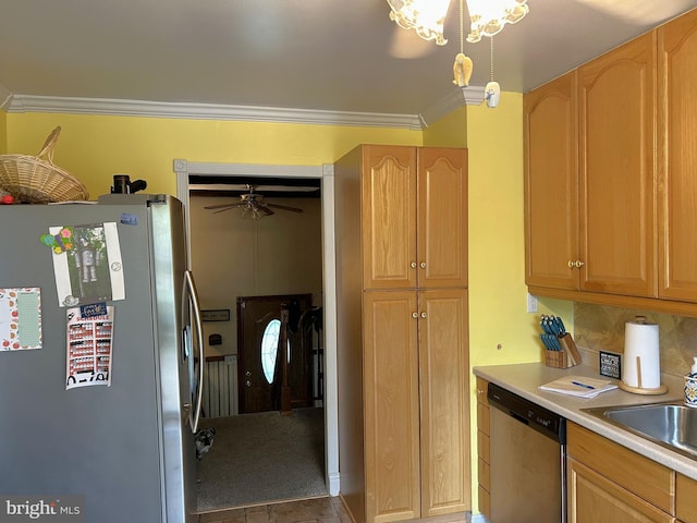 kitchen featuring a sink, crown molding, light brown cabinetry, light countertops, and appliances with stainless steel finishes