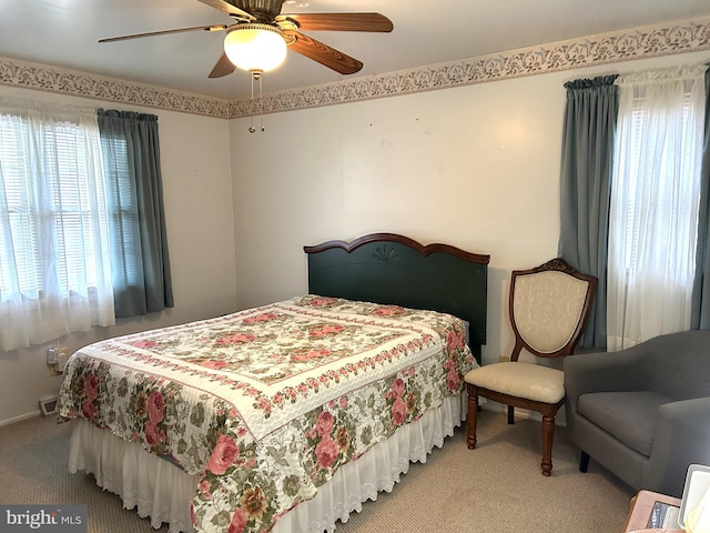 bedroom with carpet, baseboards, multiple windows, and a ceiling fan