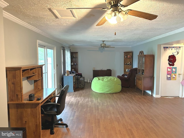 home office featuring a ceiling fan, ornamental molding, a textured ceiling, and wood finished floors