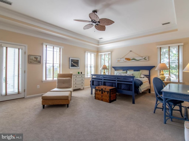 bedroom with visible vents, a tray ceiling, carpet floors, and crown molding