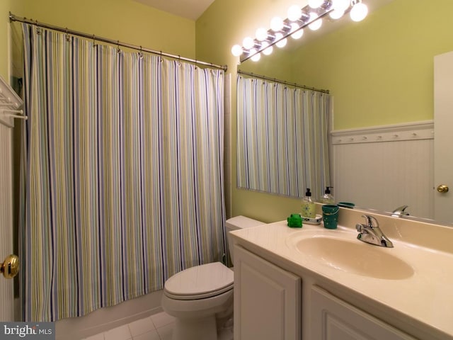 full bathroom featuring tile patterned flooring, toilet, and vanity