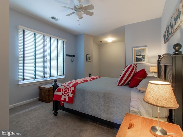 carpeted bedroom featuring visible vents, a ceiling fan, and baseboards