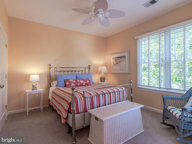 bedroom with baseboards, a ceiling fan, visible vents, and carpet flooring