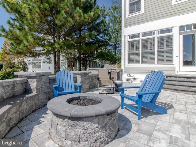 view of patio / terrace featuring an outdoor fire pit