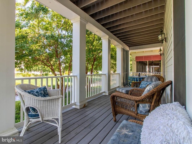 wooden terrace featuring covered porch