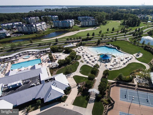 drone / aerial view featuring golf course view and a water view